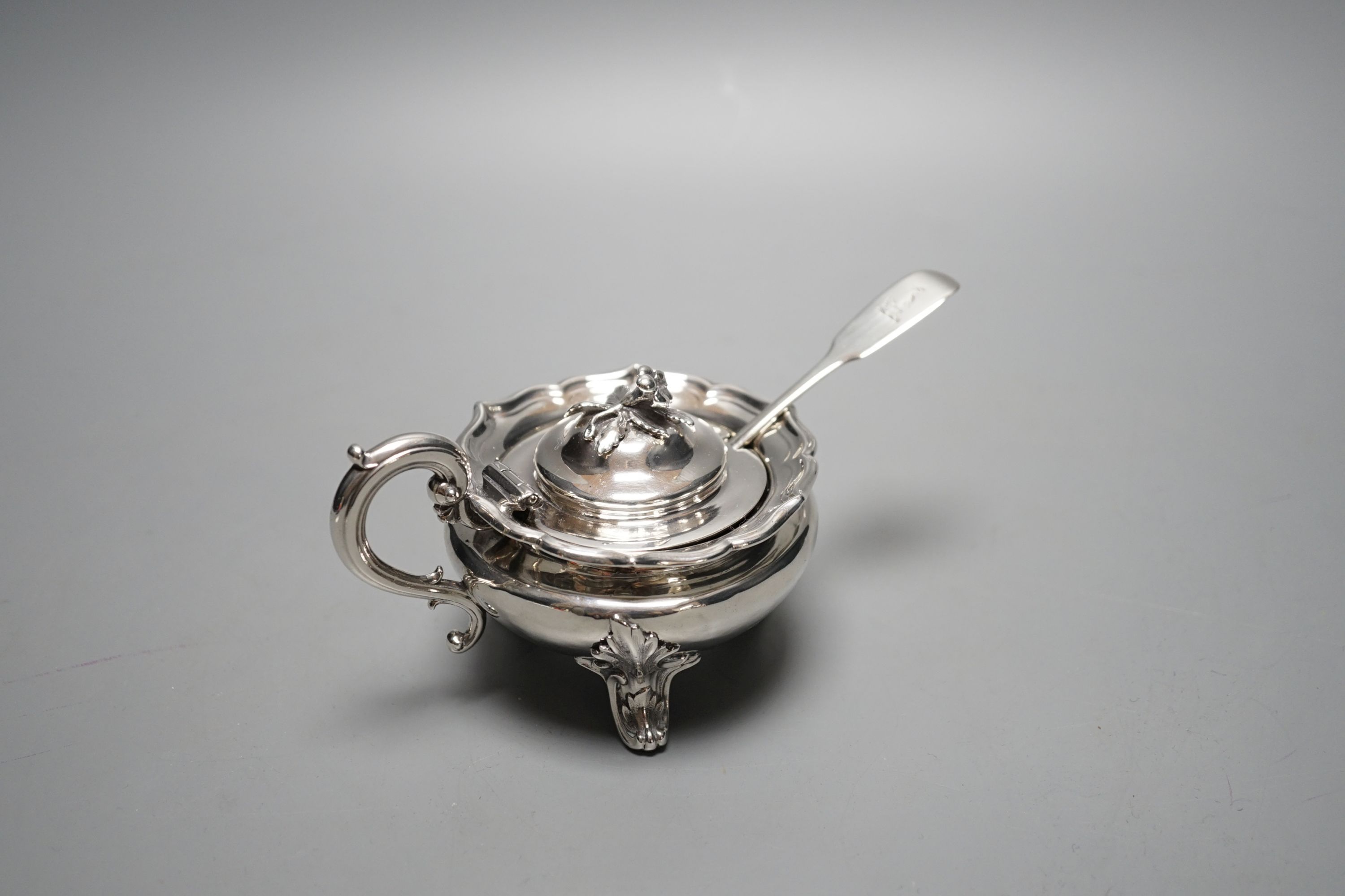 A late William IV silver circular mustard pot, with blue glass liner, The Barnards, London, 1837, with earlier associated fiddle pattern mustard spoon.